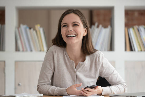 istock Smiling Caucasian girl look to side talking with mate 2202467814