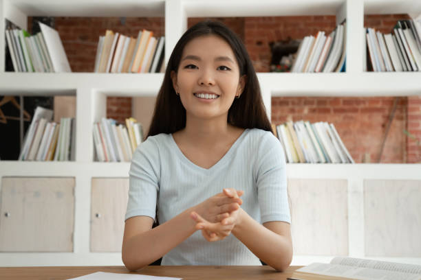 istock Smiling Asian female coach talk on camera having video call 2202468005