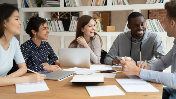 istock Happy multiethnic students have fun studying indoors together 2202468184