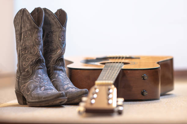 istock country boots and acoustic guitar 2202468244