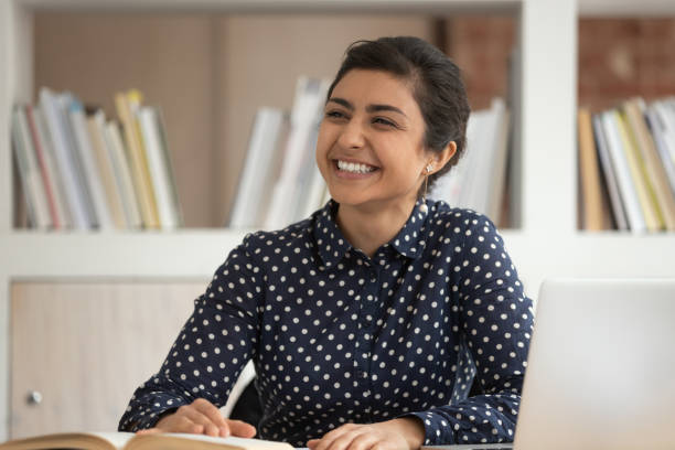 istock Smiling indian millennial girl talking with teammate 2202468267