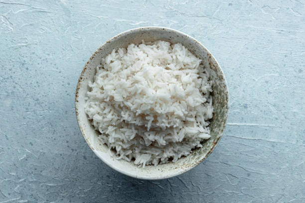 White rice, cooked. A bowl of boiled long grain rice, a simple side dish
