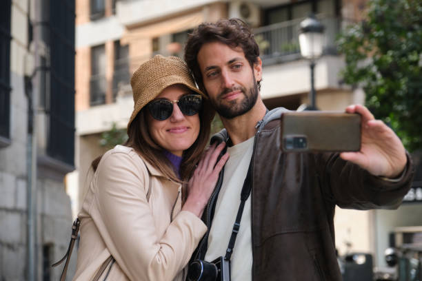 istock Tourists couple taking selfie while visiting city 2202468682