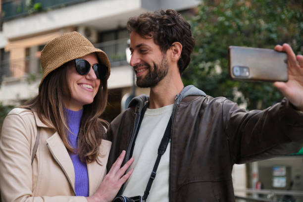 istock Tourists couple taking selfie while visiting city 2202468867