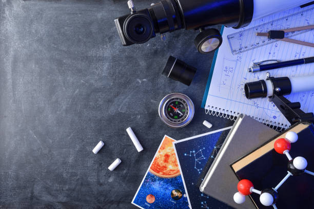 istock Material books and telescope for study of astronomy on blackboard 2202469531