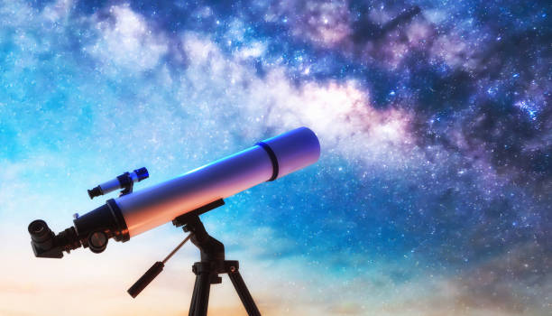 istock Telescope on tripod pointing at a starry sky at dusk 2202469536
