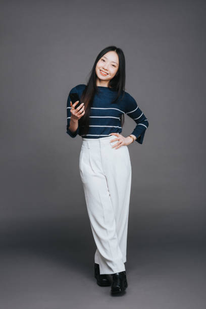 istock Well dressed asian woman on a grey studio background 2202469617