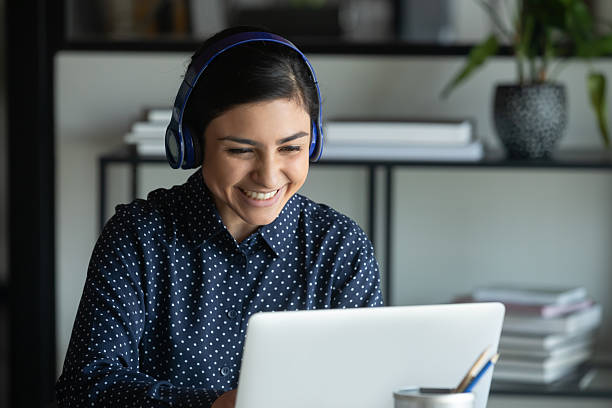 istock Smiling Indian woman have video call on laptop 2202470465