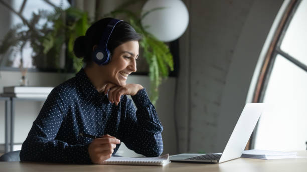 istock Smiling female employee talk on video call on computer 2202470591