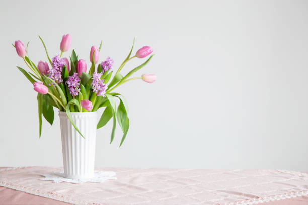 istock spring flowers in white vase in vintage style 2202472454