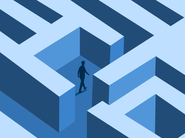 istock Businessman walking to find a way out of a maze 2202472599