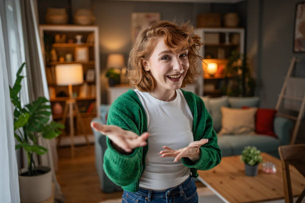 istock Young woman making a video call from her living room 2202472720
