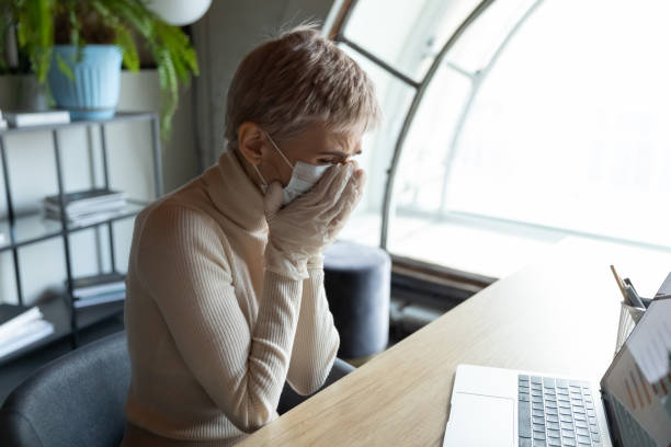 istock Sick female employee infected with covid-19 in office 2202473083