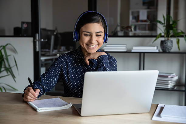 istock Smiling female worker in headset consult client online 2202474705
