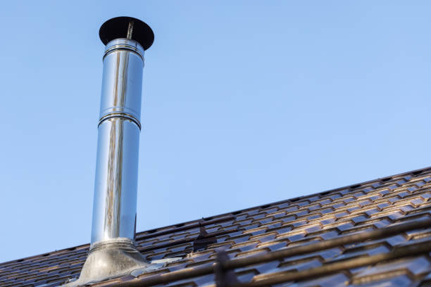 istock Shiny cylindrical metal chimney pipe with a protective cap 2202475533