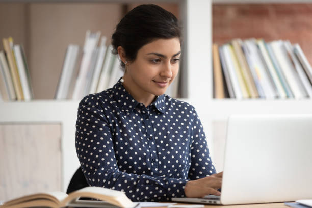 istock Focused indian female student buys studying using laptop 2202476285