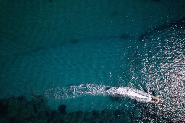 istock Cruise speed boat floating in sea along coastline 2202479881