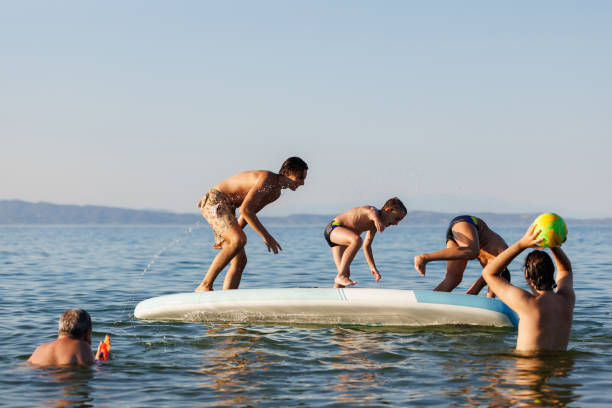 istock Kids Enjoying Summer Fun with Dad 2202480211