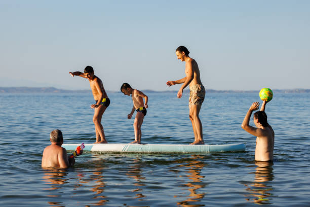 istock Father and Kids Enjoying the Sea 2202481254