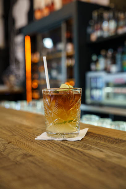 istock Dark and Stormy cocktail with lime garnish on bar counter 2202483850