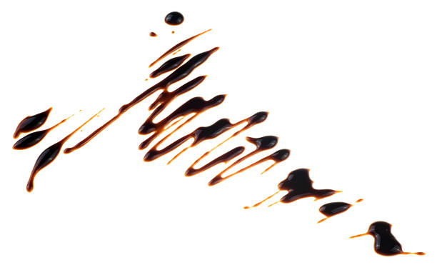 istock Liquid chocolate syrup isolated on a white background. Pancakes topping. Liquid chocolate drizzle. 2202490886