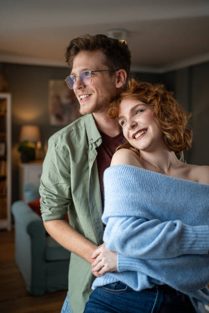 istock Young couple sharing a tender embrace at home 2202496089