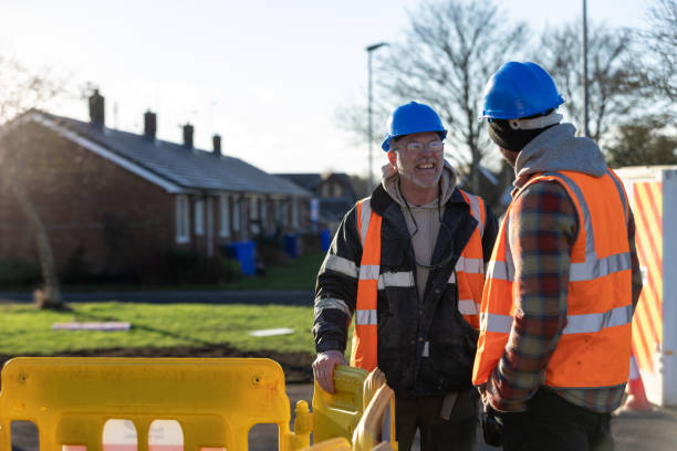 istock Builders Talking at an Outdoor Worksite 2202496176