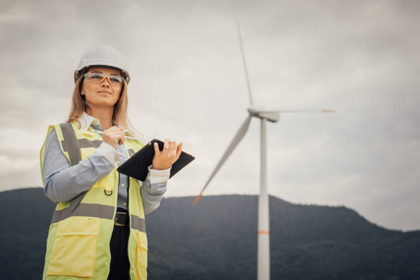 istock A dedicated female engineer oversees complex wind farm operations, showcasing her expertise and leadership in sustainable energy, innovation, efficiency, and environmental integrity 2202496430