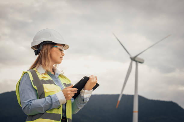 istock A skilled female engineer is diligently inspecting a wind turbine at a renewable energy site, focusing on ensuring safety, sustainability, and innovative technologies in the engineering field 2202496509