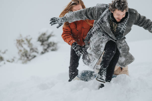 istock Friends playing together in the snow during a cold winter day 2202497897