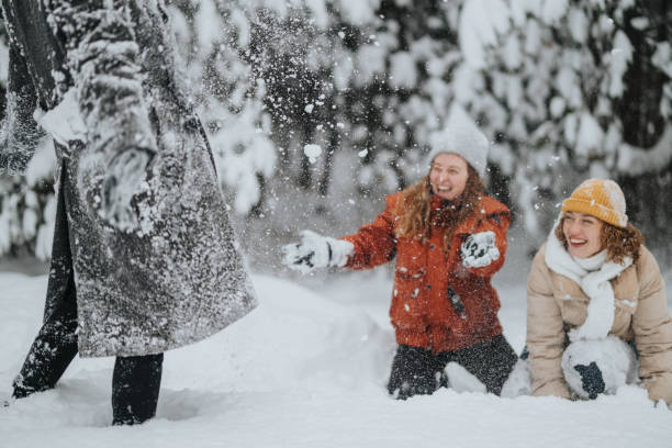 istock Friends enjoying a playful winter day outdoors in the snow 2202498024