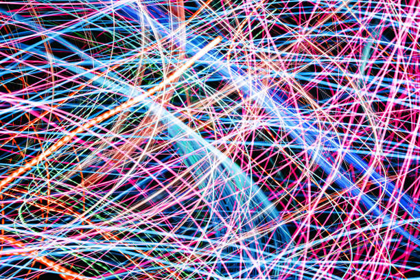 istock Vibrant web of colorful neon lights in motion. Abstract glowing lines creating a dynamic illuminated mesh pattern. 2202506637