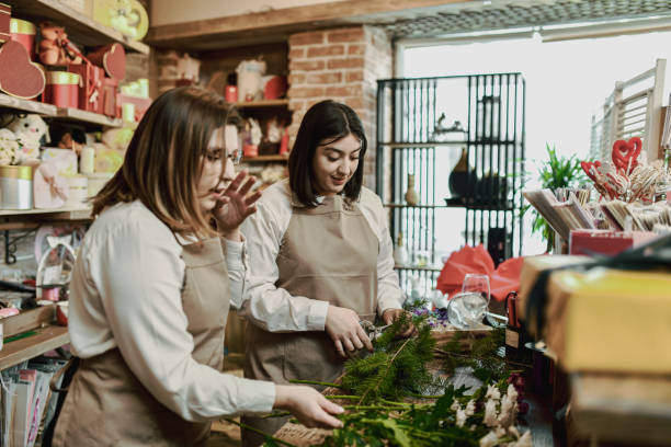 istock Lovely Florist Colleagues Spending Time at Flower Shop Creating Customized Bouquets 2202506765