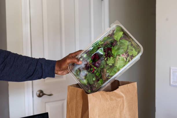 istock A Black Man Taking A Salad Container Out Of A Grocery Bag 2202506862