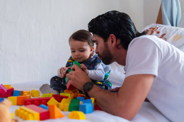 istock A morning at home with dad, playing on the couch at home 2202507653