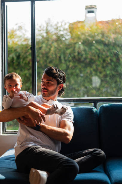 istock A morning at home with dad, playing on the couch at home 2202507805