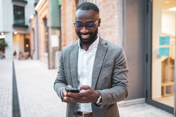 istock Confident businessman using smartphone in an urban outdoor setting 2202516844
