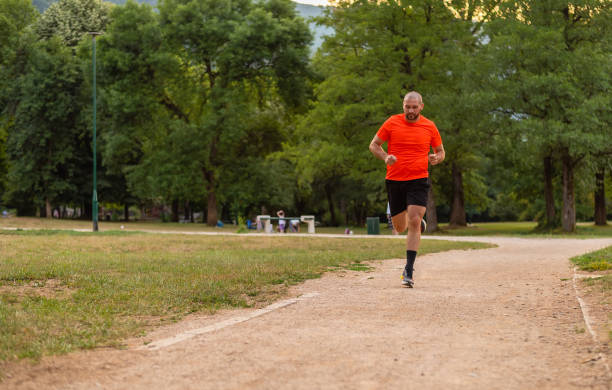 istock Sporty man running or jogging at the park. 2202519326