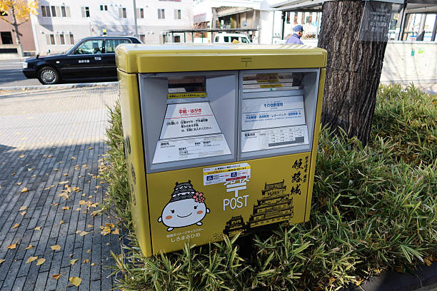 Himeji, Japan- 11 Dec 2024: yellow postbox with mascot Shiromaruhime drawing on the postal box for sending local and international post