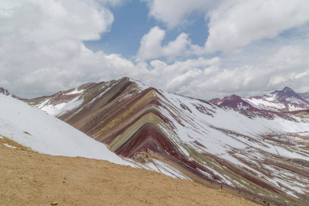 Tourists visiting the colorful vinicunca mountain in peru