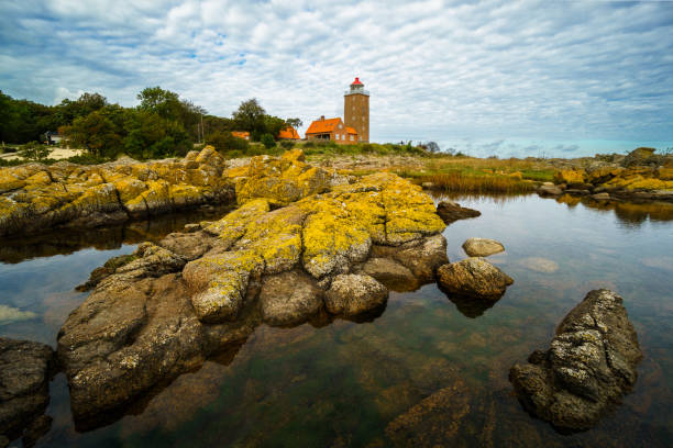 istock Lighthouse on rocky shore with dramatic sky, Svaneke, Bornholm, Denmark 2202521661