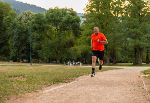 istock Sporty man running or jogging at the park. 2202521898