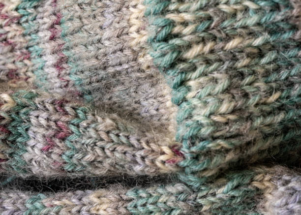 istock knitted socks made of wool yarn, handicraft concept, knit 2202522017