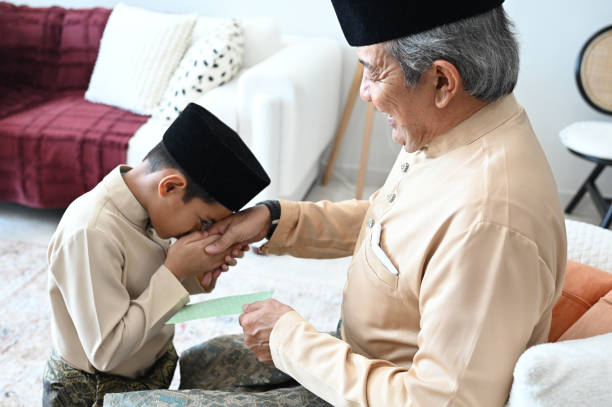 istock Cherishing Traditions: A Malay Kid Seeks Blessings and Receives Duit Raya