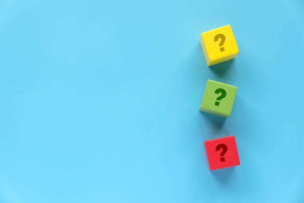 istock Colorful Wooden Blocks with Question Marks on Blue Background 2202523464