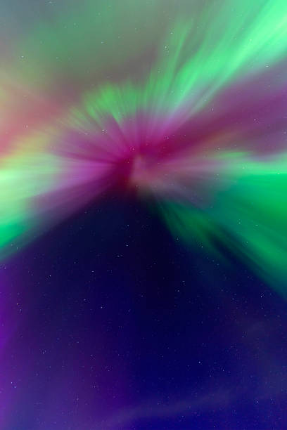 istock Aurora borealis illuminating the night sky with vibrant colors 2202524288