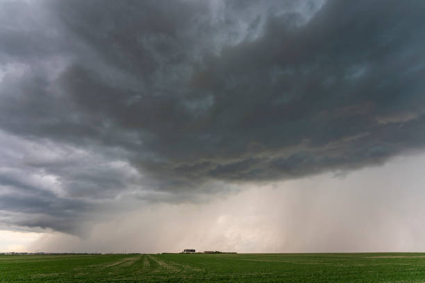 istock Dark storm clouds gathering over farmland 2202525159