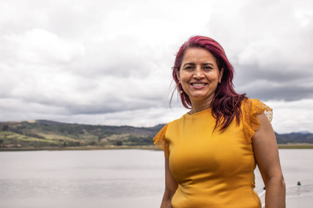 istock Cheerful old - senior woman posing by a lake 2202525434