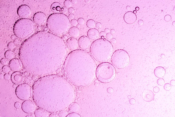 istock Pink macro bubbles background,Abstract pink oil bubbles background. Cosmetic liquid beauty product. 2202525603