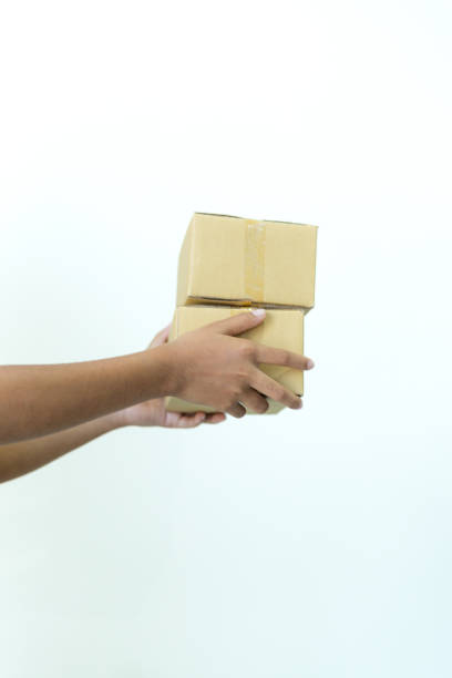 istock Human hand holding parcel box isolated on white background,man's hand with cardboard box on white background 2202525710